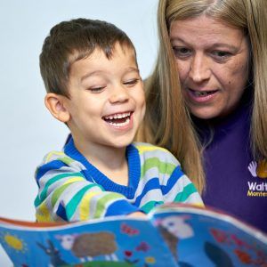 Children reading with staff member at the Walton Montessori